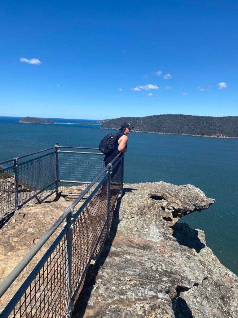 girl on the edge of warrah lookout in patonga